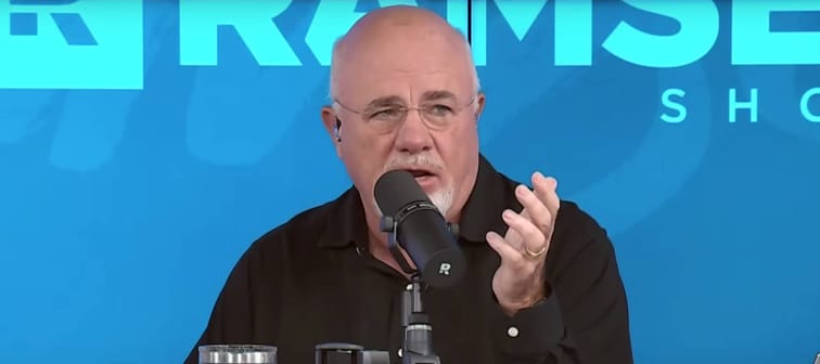 Dave Ramsey speaks with his hands in a gesture on the set of his radio show.