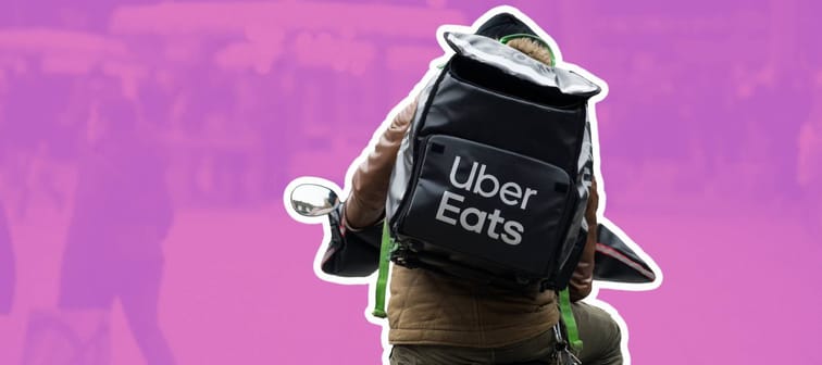 Uber Eats bicycle messenger wearing a branded backpack