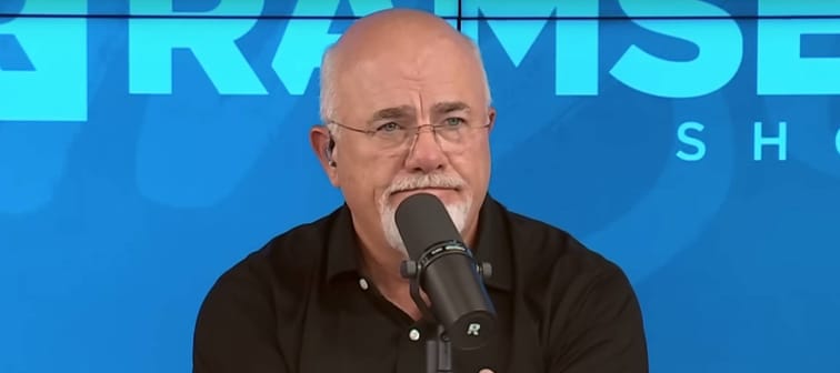Dave Ramsey on the set of his radio show making an exaggerated disappointed face.