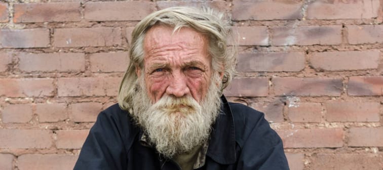 Old man sitting in a parking lot in Dallas.