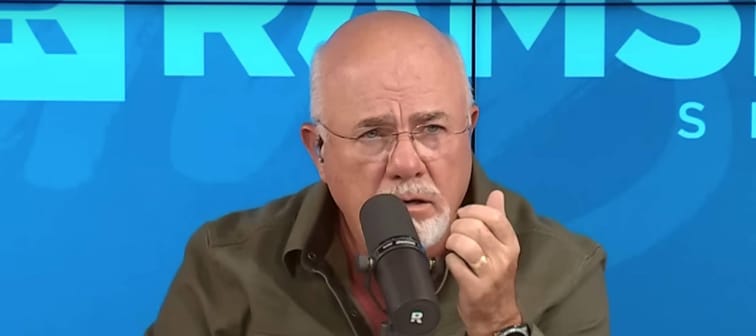 Dave Ramsey on the set of his radio show, looking incredulous with his eyes and mouth wide open.