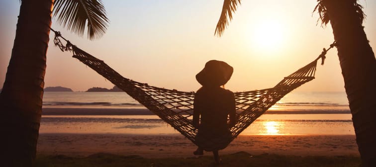 woman relaxing in hammock at sunset on the beach, enjoy the life
