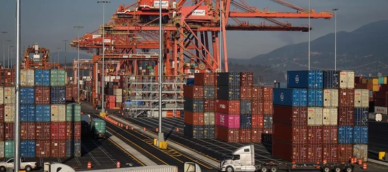 Statistics Canada says the country posted a merchandise trade deficit of $2.3 billion in March. A truck carries a cargo container at the Port of Vancouver Centerm container terminal in Vancou