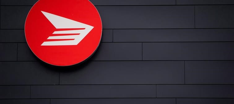 Canada Post says it lost $748 million before tax last year as it warned of larger, unsustainable losses ahead. The Canada Post logo is seen on the outside the company's Pacific Processing Cen