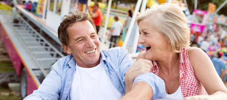 A couple enjoy themselves at an amusement park.