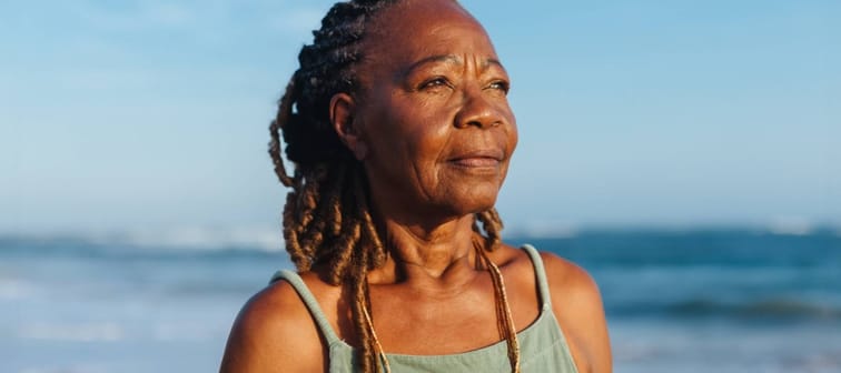 mature African American woman enjoys a peaceful moment by the sea