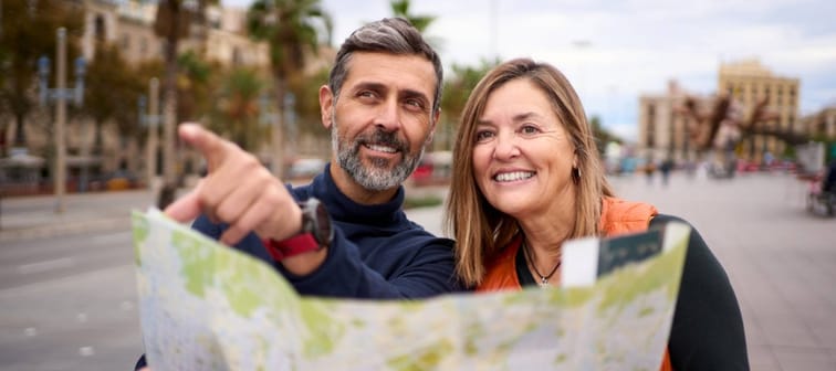 Middle-aged Caucasian couple with travel map