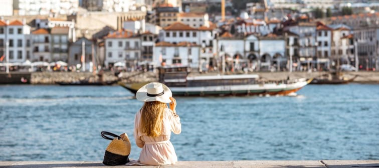 A woman enjoys the view during a sunny day in Porto, Portugal.