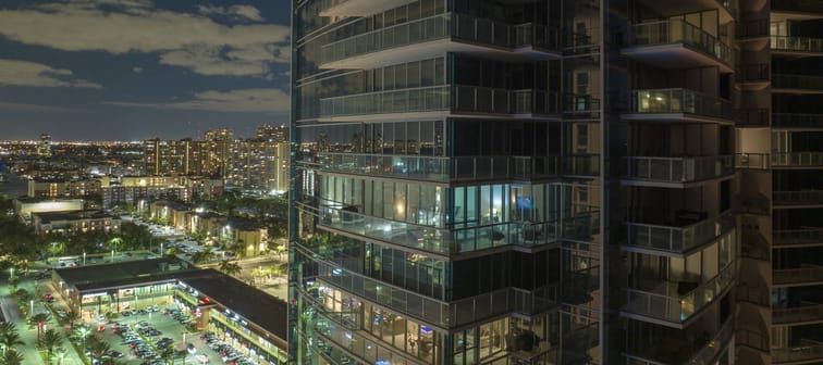 Aerial view of residential high-rise skyscraper at night in Sunny Isles Beach city in Florida.