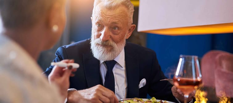senior Caucasian man fine dining with a male companion