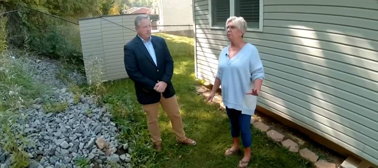Donna Schwartzbauer purchased a plot of land from the state for $15,000, but says she's had problems with the sliding hillside behind her home.