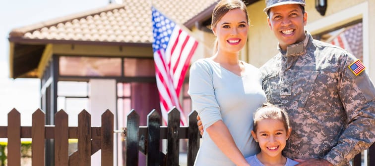 happy american soldier reunited with family outside their home