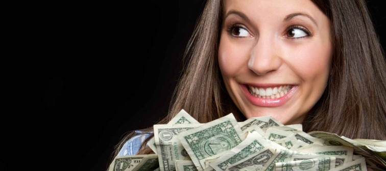 Beautiful smiling woman holding money