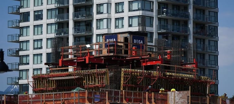 Workers are seen on a condo tower under construction in Coquitlam, B.C., on Tuesday, May 16, 2023. British Columbia's construction industry says its workforce numbers have improved in recent 