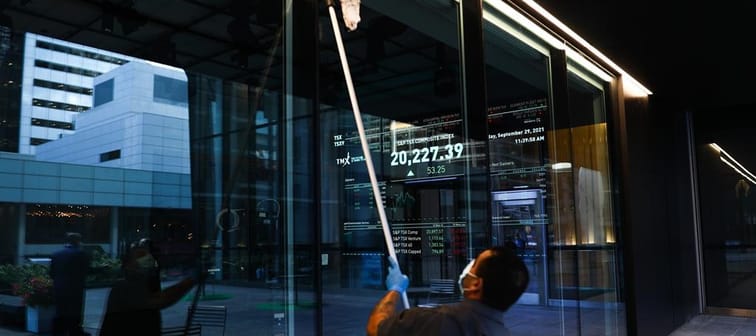 A signboard displays the TSX as a custodian cleans the windows of the Richmond Adelaide Centre in the financial district in Toronto on Wednesday, September 29, 2021. 