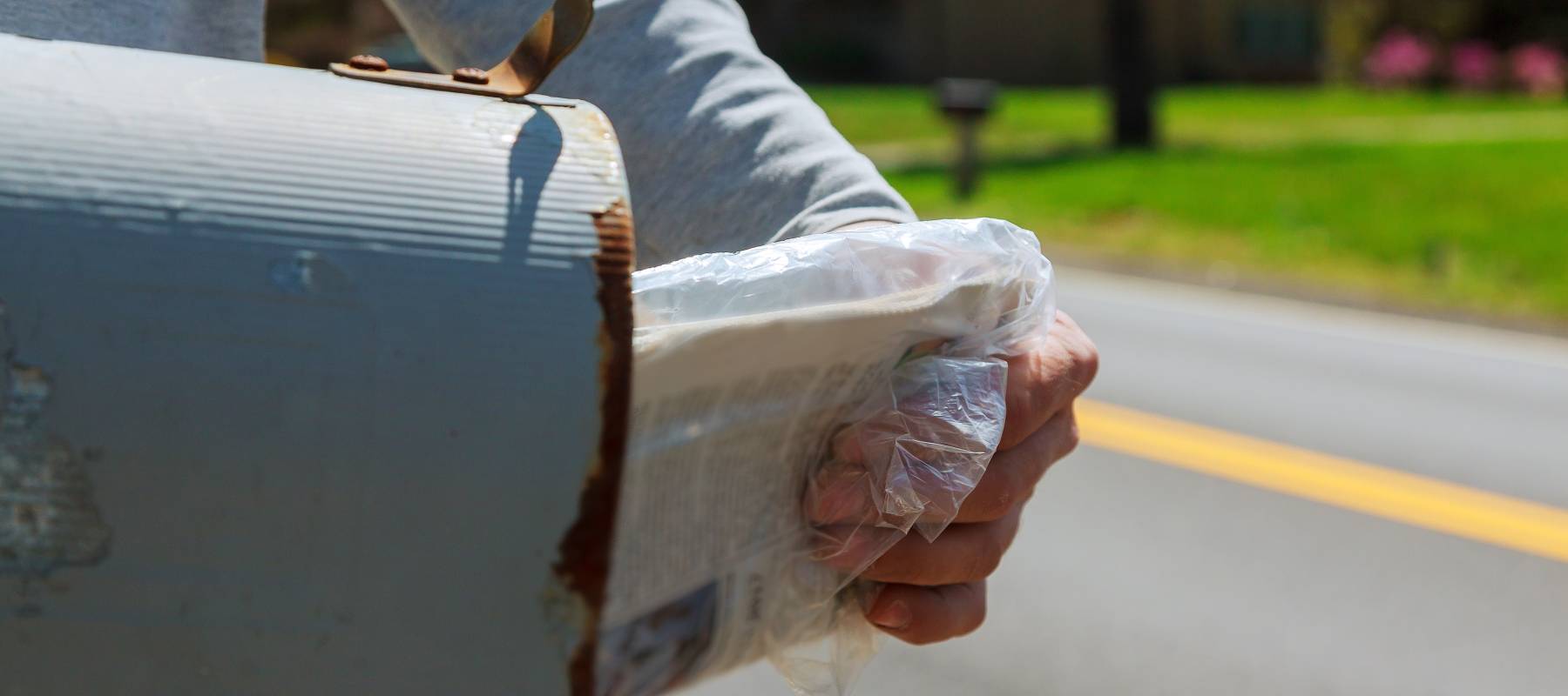 Man's hand pulling mail out of mailbox