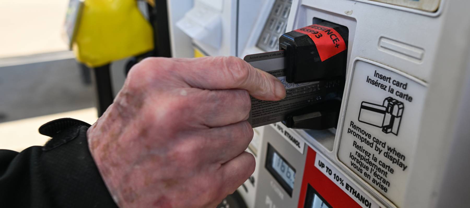 Man paying for gas with a credit card