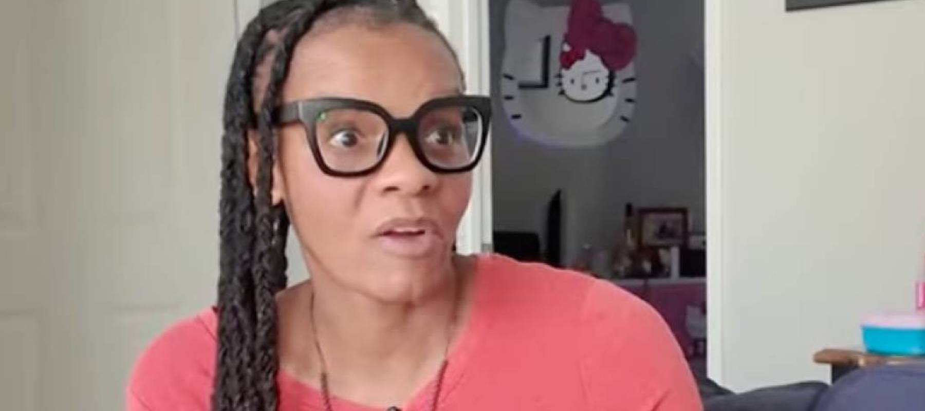 Woman, with a surprised expression, talking to a reporter.