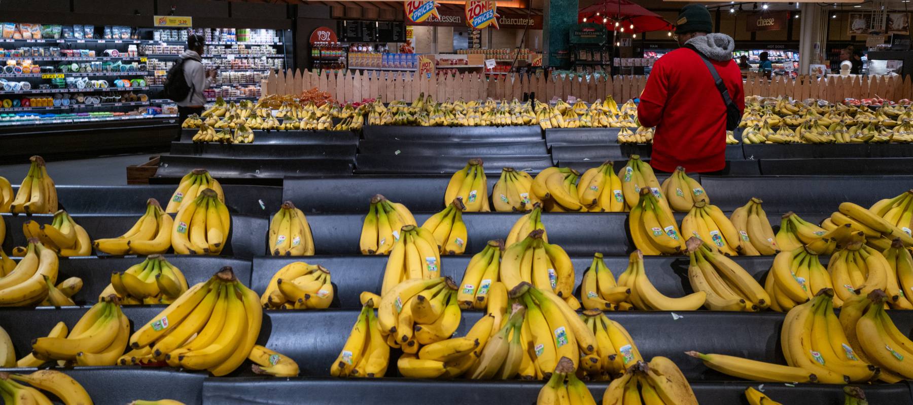 Customer shopping for bananas.