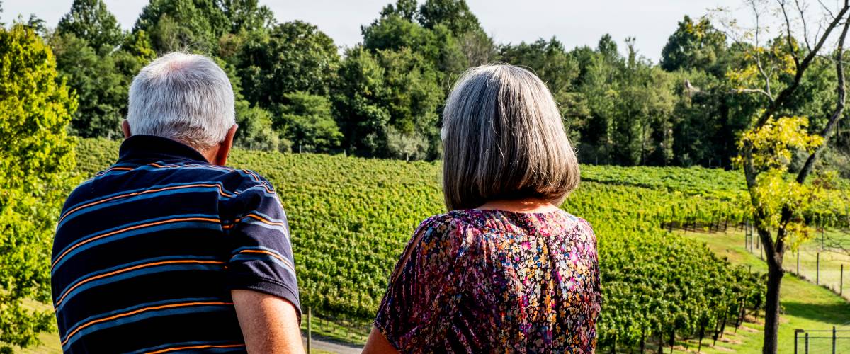 Older couple overlooking a vineyard