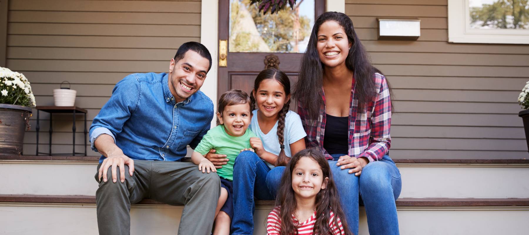 Family walking sitting on front steps
