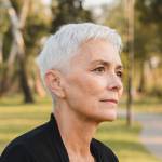 Contemplative Elderly Woman Relaxing on a Park Bench in Autumn