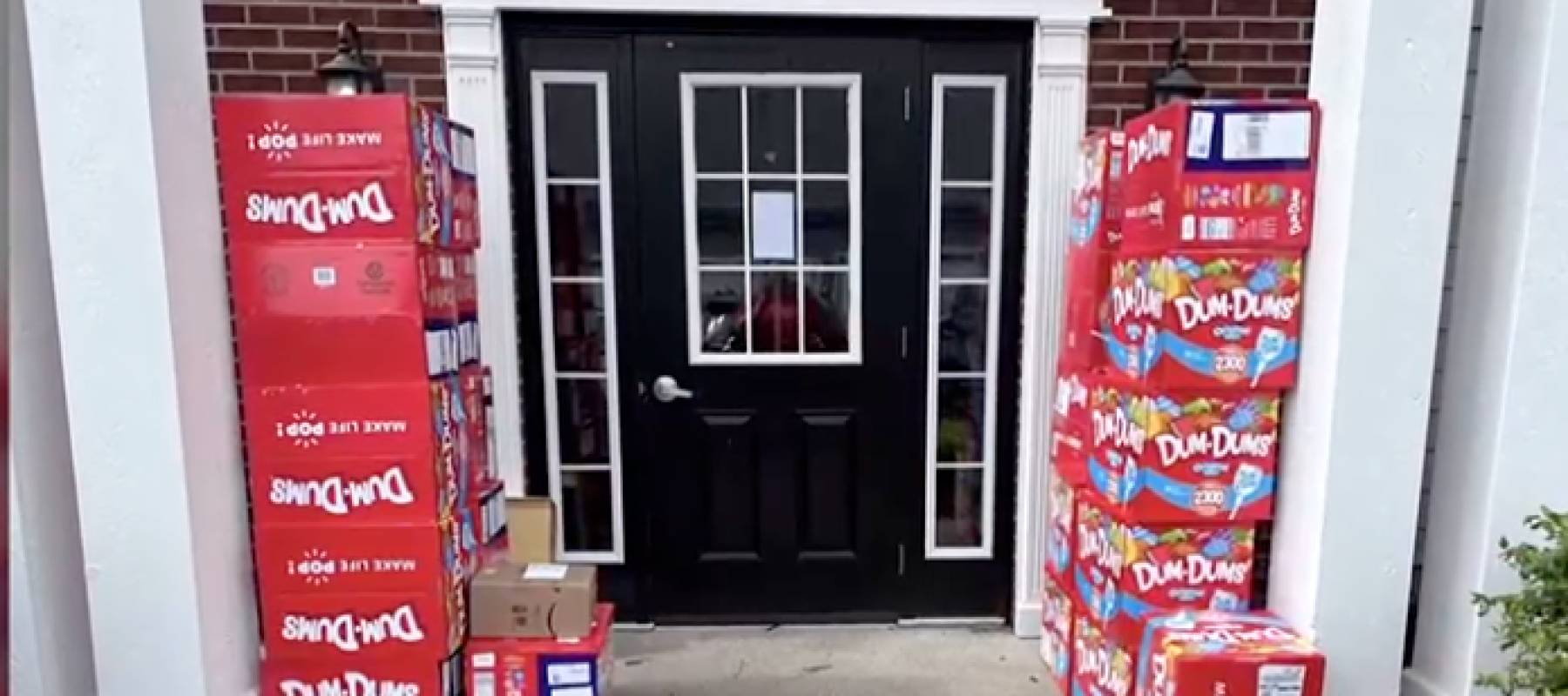 Numerous boxes stacked on a front porch.