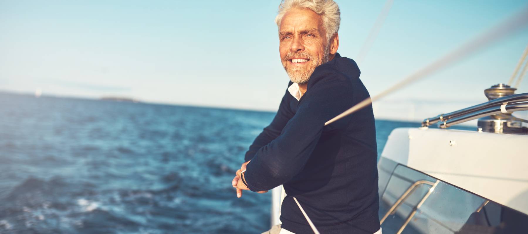 Happy man enjoying a ride on his boat