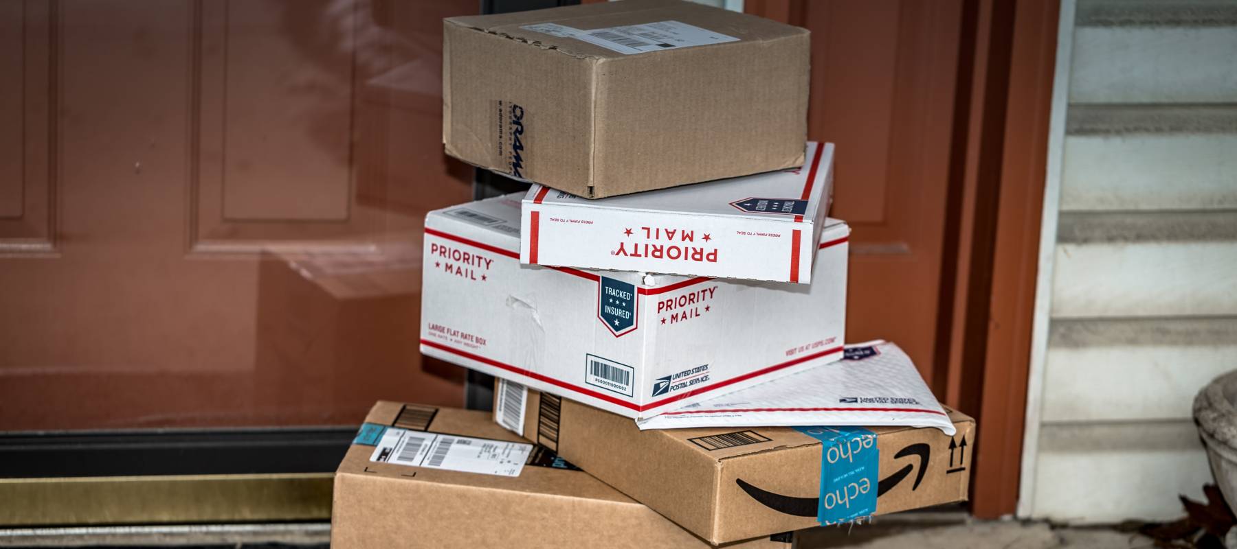 Packages piled on porch.