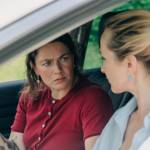 Two upset female travelers in a car