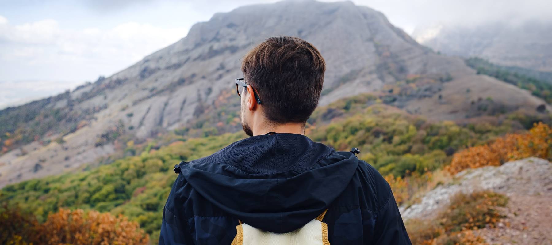 Active backpacker hiking in colorful nature.