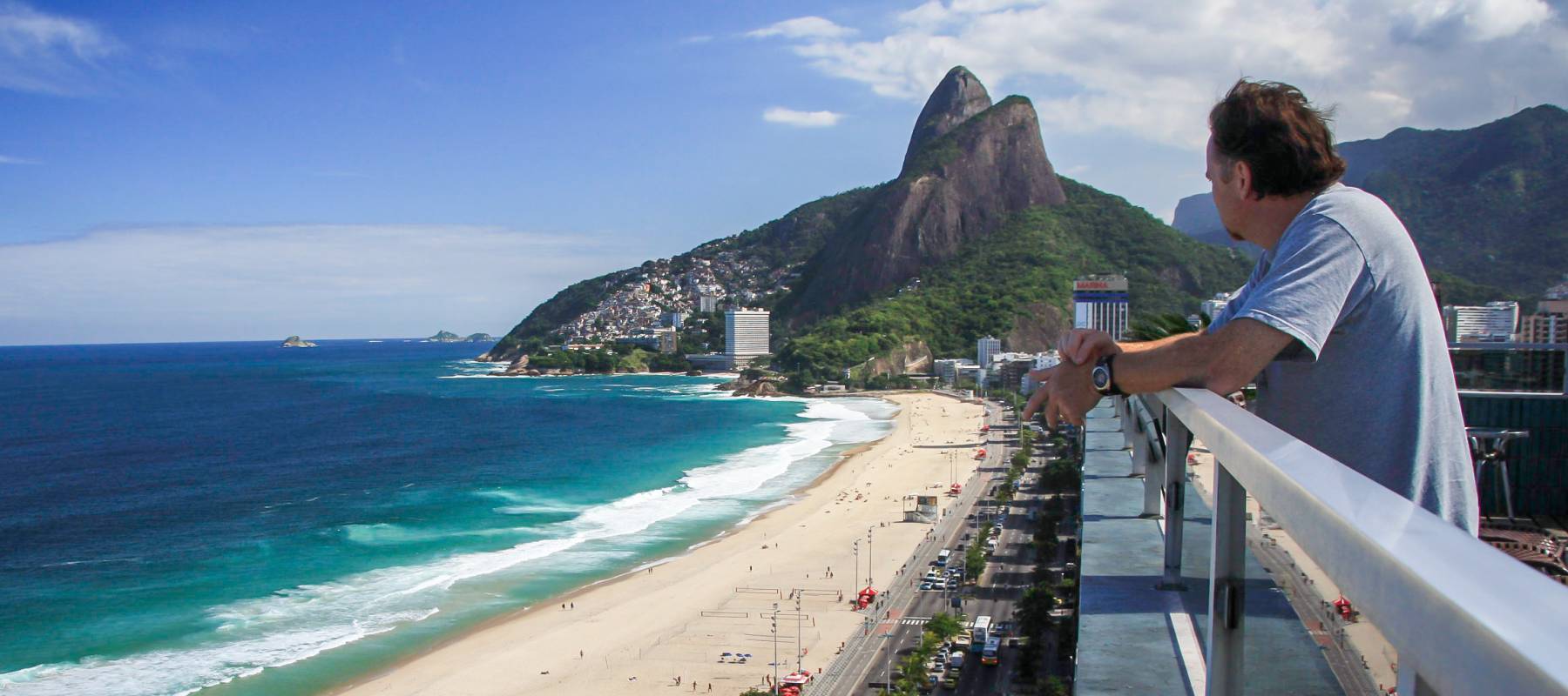Man overlooks a beach.