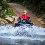 The girl driving an ATV through the river Spree.