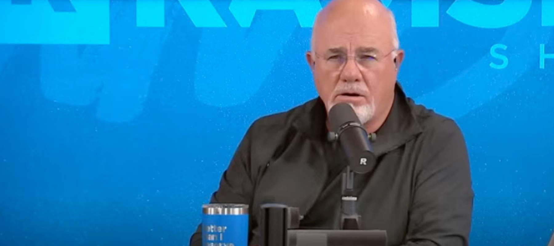Dave Ramsey speaking in front of.a mic.
