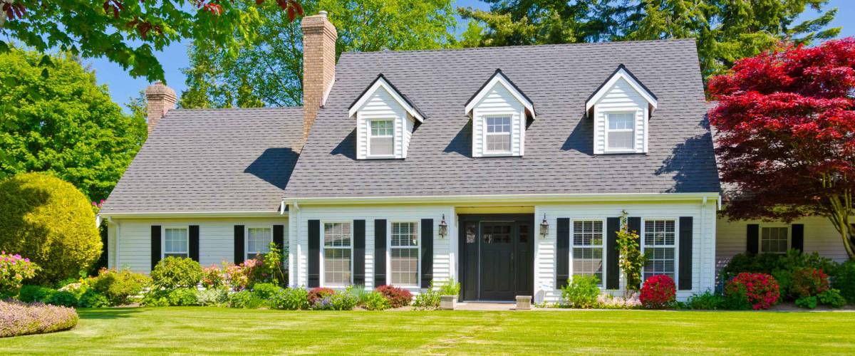 Custom built luxury house with nicely trimmed and landscaped front yard, lawn in a residential neighborhood. Vancouver Canada.