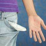 close-up of the hand of a man showing the pocket of his pants empty