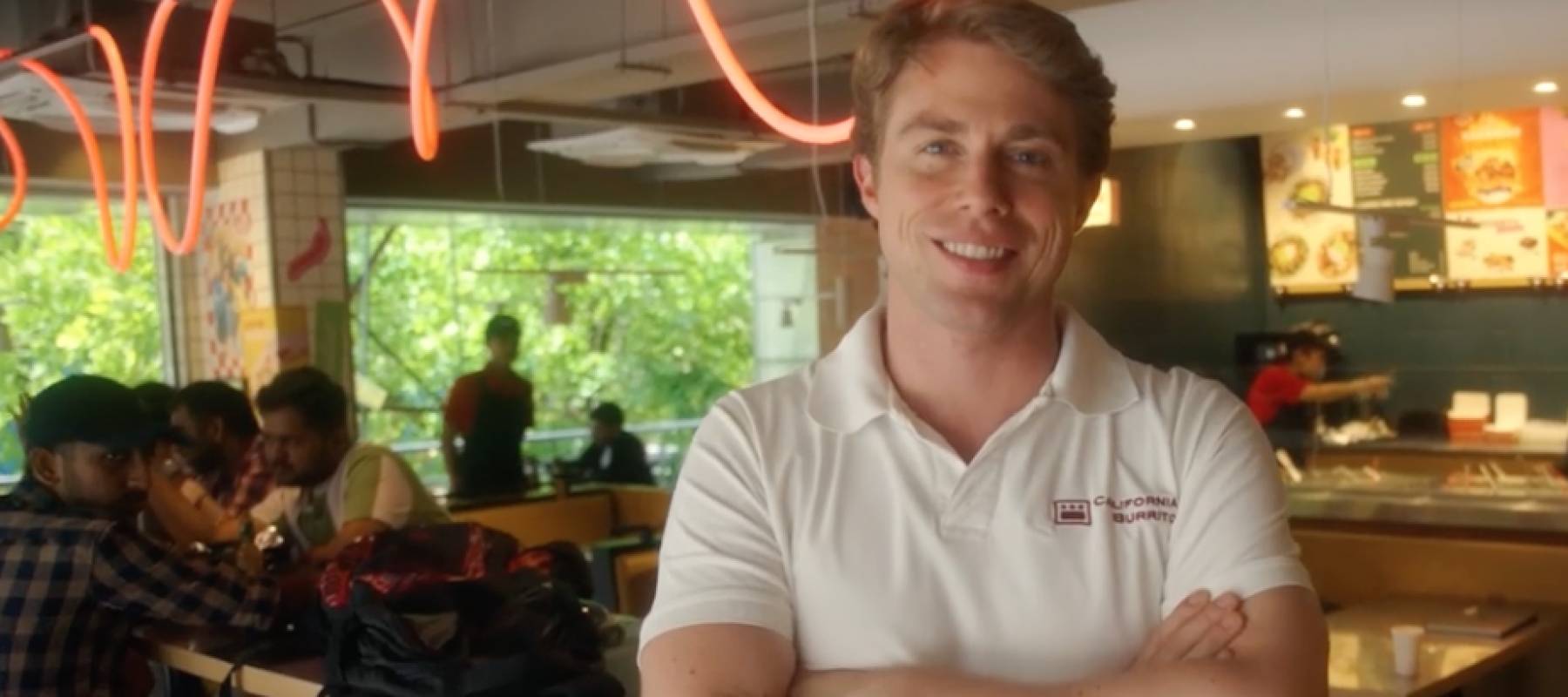 Man smiling at a restaurant.