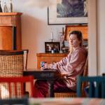 Young woman sitting at table with mug