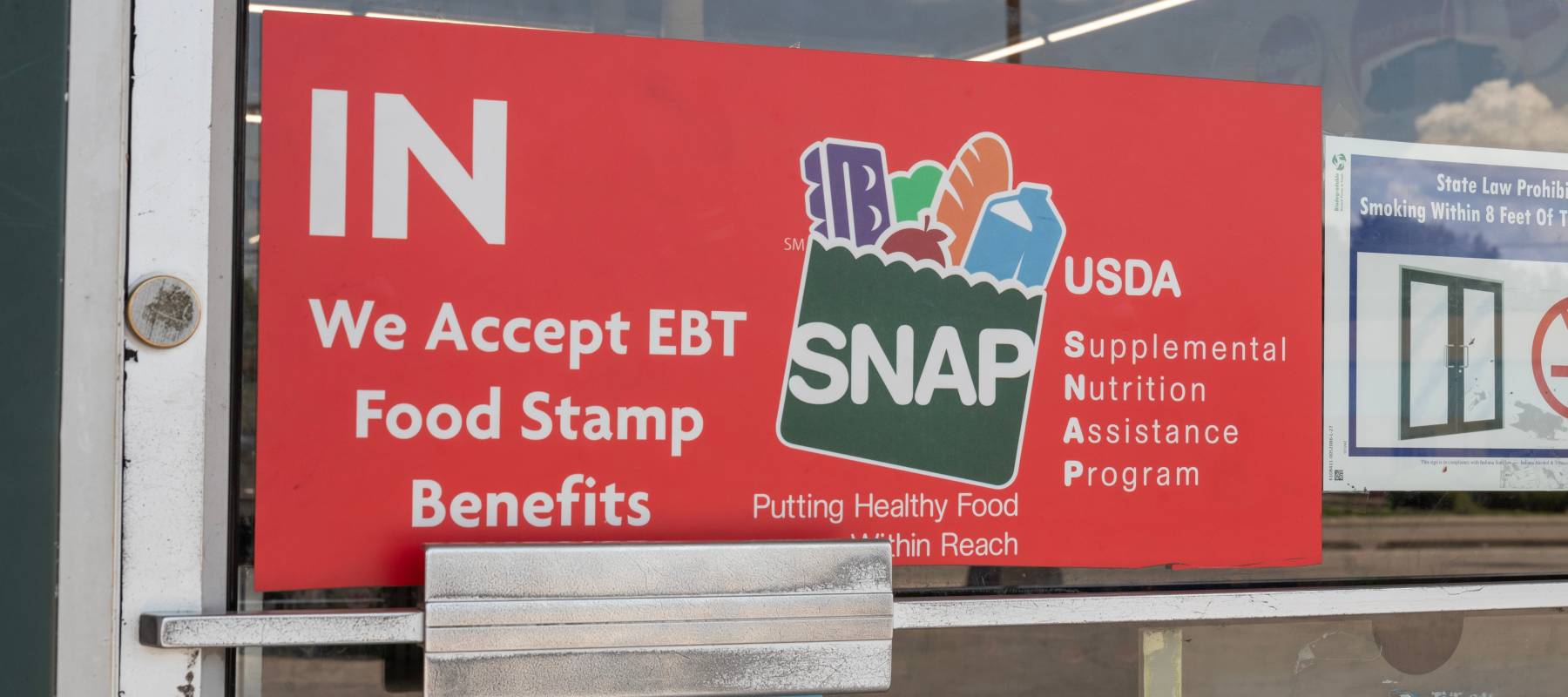 A storefront advertising the acceptance of SNAP benefits.
