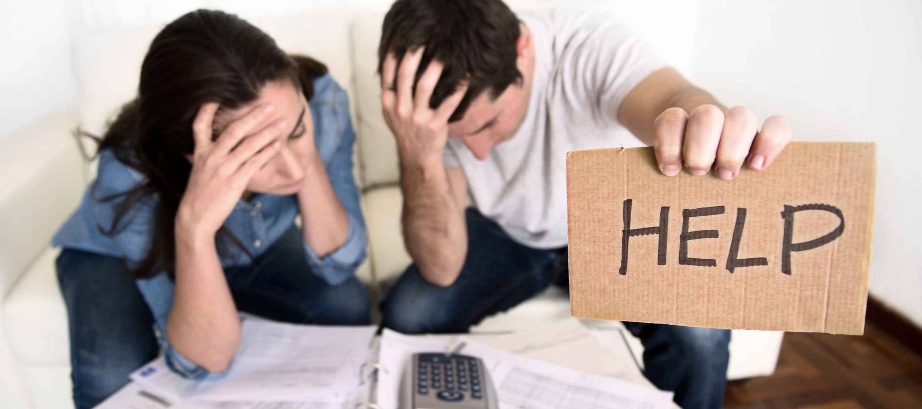 young couple worried need help in stress at home couch accounting debt bills bank papers expenses and payments feeling desperate in bad financial situation