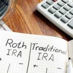 Roth IRA vs Traditional IRA written in the notepad.