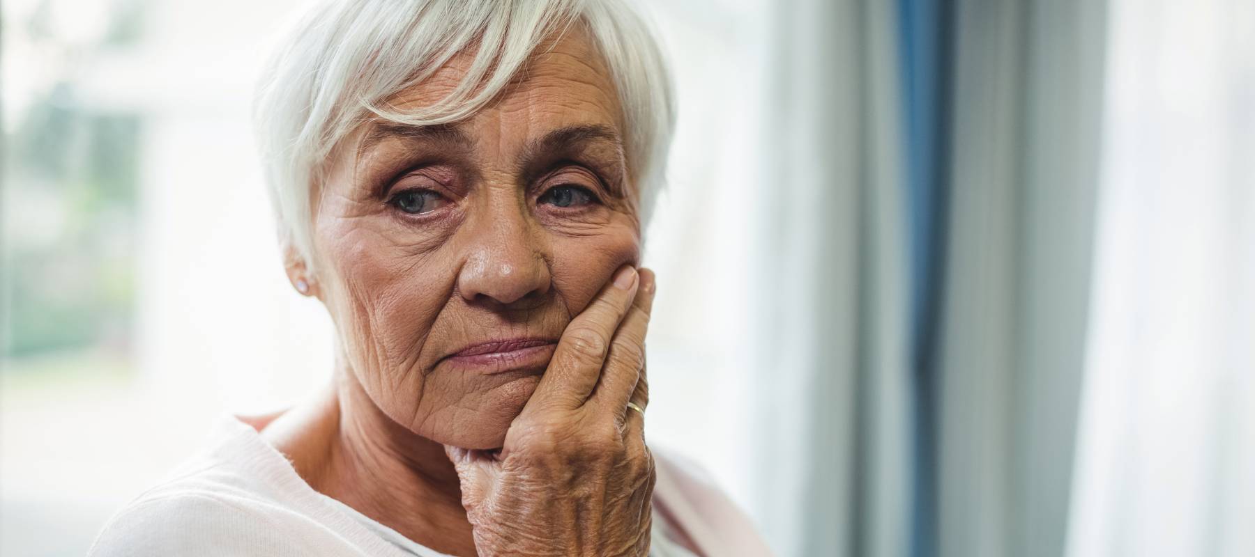 Close-up of worried senior woman with hand on her face