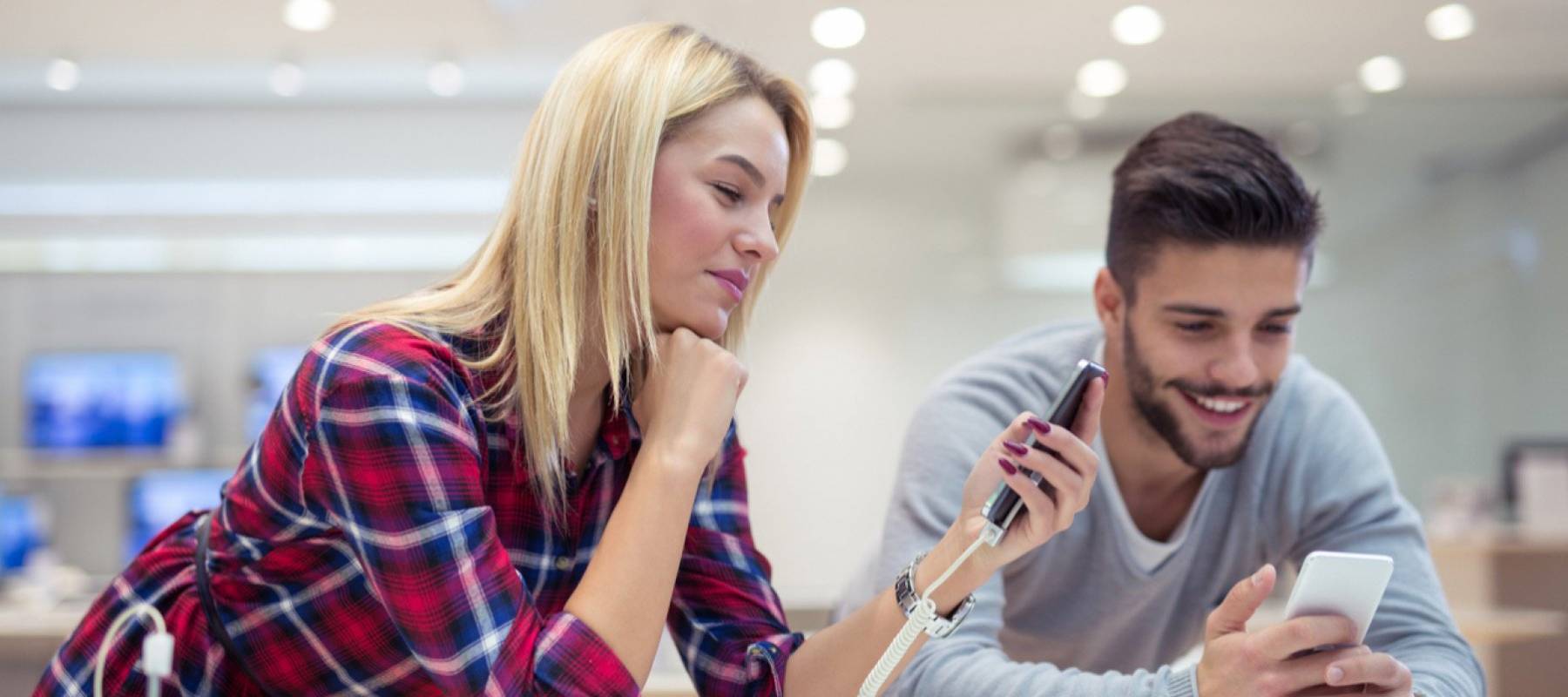Couple in a store, looking at their smartphones