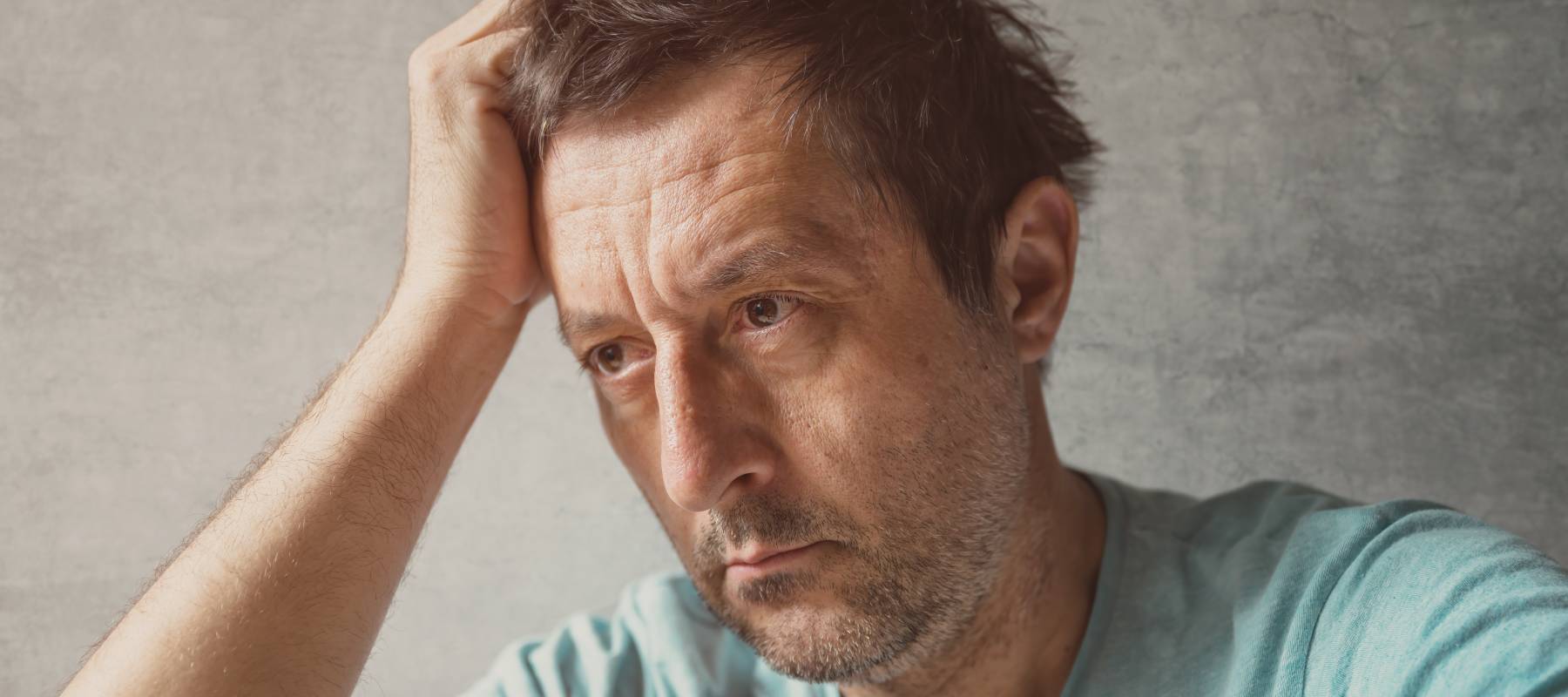 A pensive, middle-aged man considers life choices.