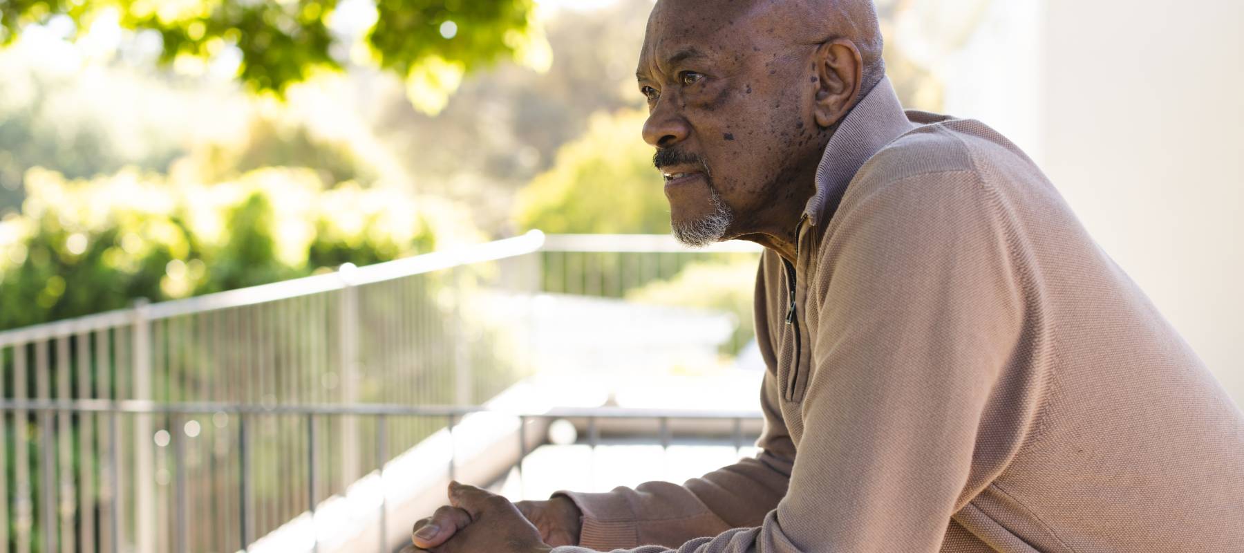 Elderly man thinking outside.