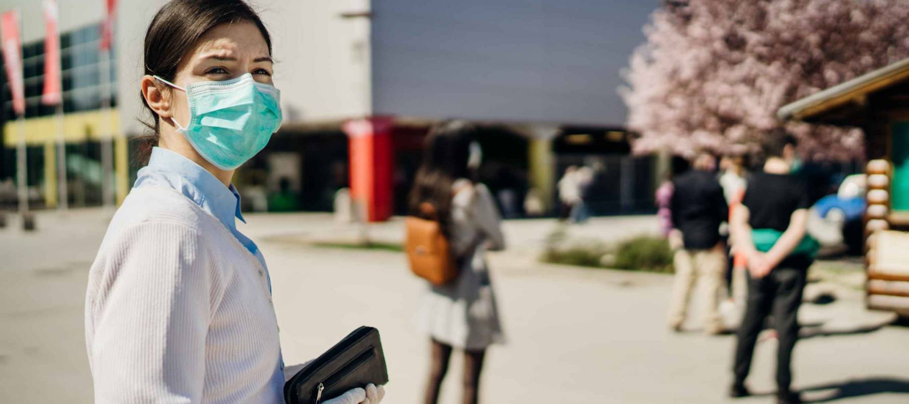 Shopper with mask standing in line  to buy groceries
