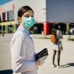 Shopper with mask standing in line  to buy groceries