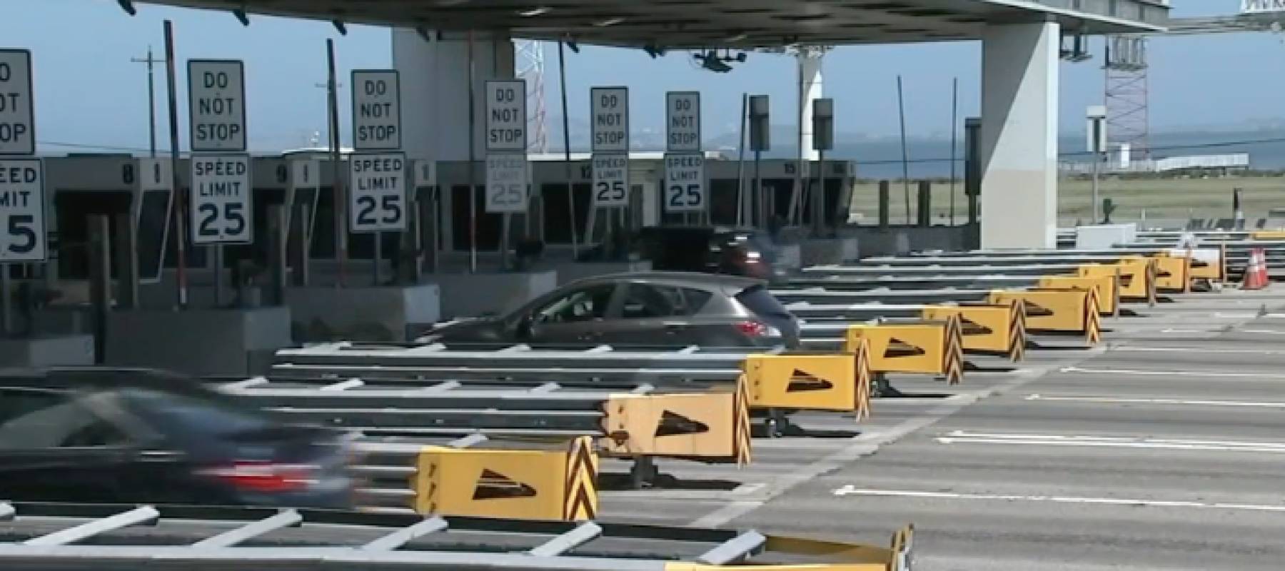 Cars at a toll plaza.