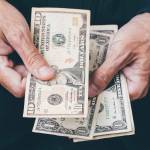 Close up of poor man hand with small money