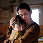 Portrait of sad poor mature mother hugging